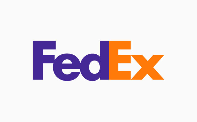 A logo of the FedEx company