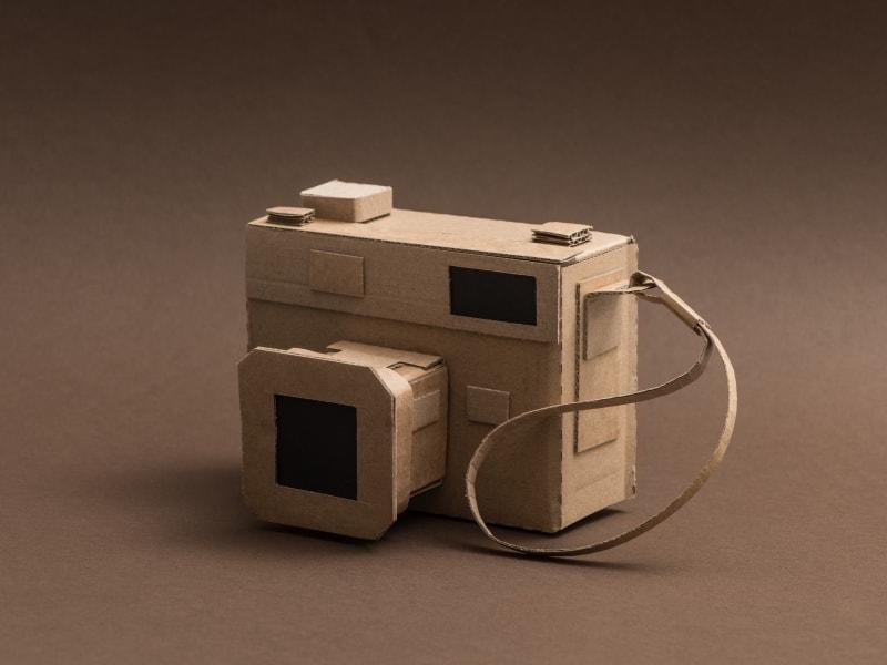 An image of a creative hand made camera out of cardboard illustrating a creative mass