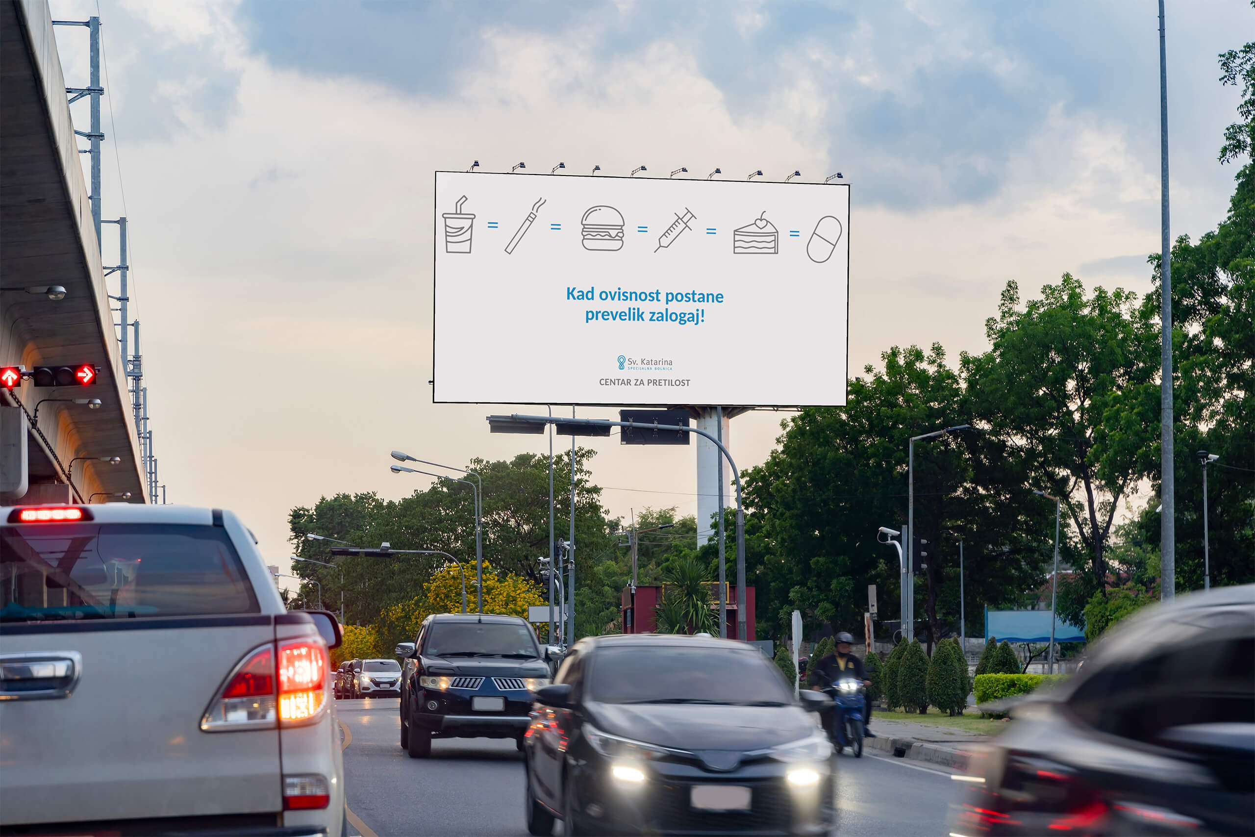 An billboard for St. Catherine's Hospital - obesity center, that says when the addiction becomes too much (and symbols of addiction cigarettes, alcohol, sugars are shawn).
