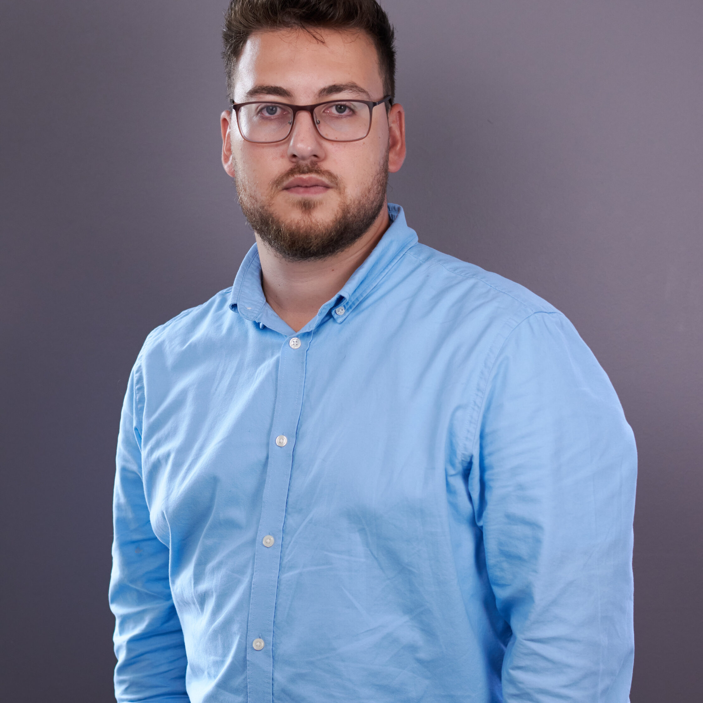 A handsome guy with glasses and in a blue shirt. Smart also.