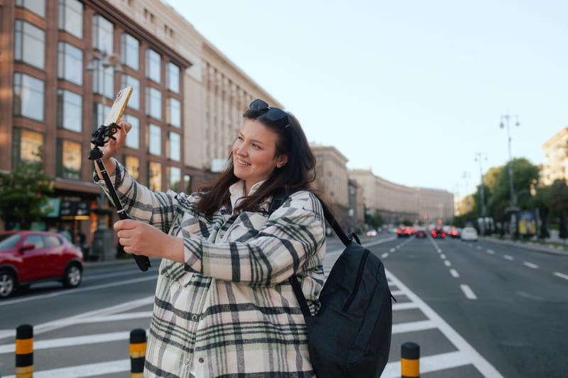 a woman filming herself on the street for socail media