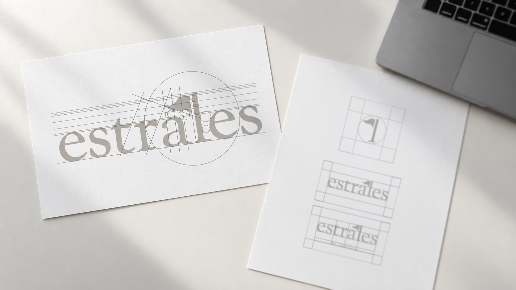 Estrales logo construction and safe zone guidelines shown on printed brand identity sheets.